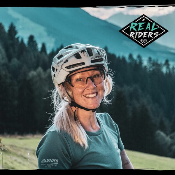 Female with helmet and glasses smiling