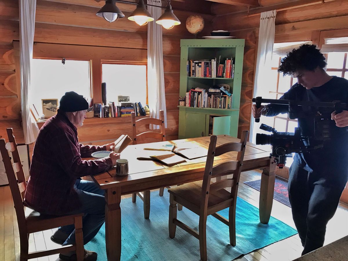 Kieran Nikula filming in his log cabin